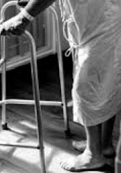older person using walking frame in hospital