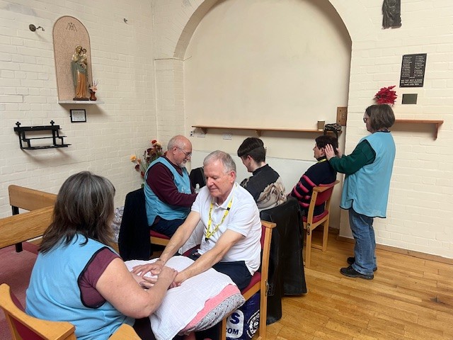 A group of people receiving hand massages.