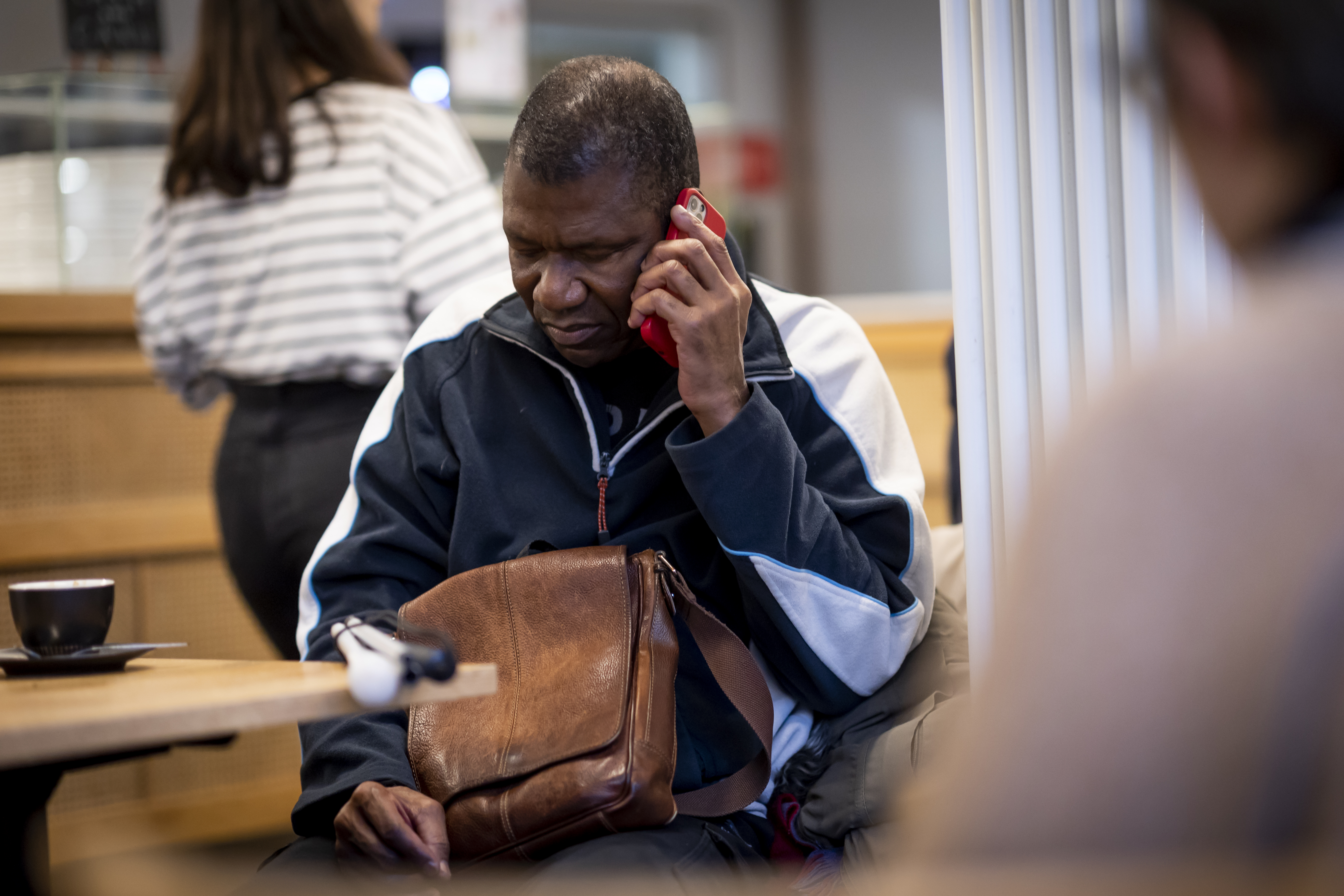Man using mobile phone in a café