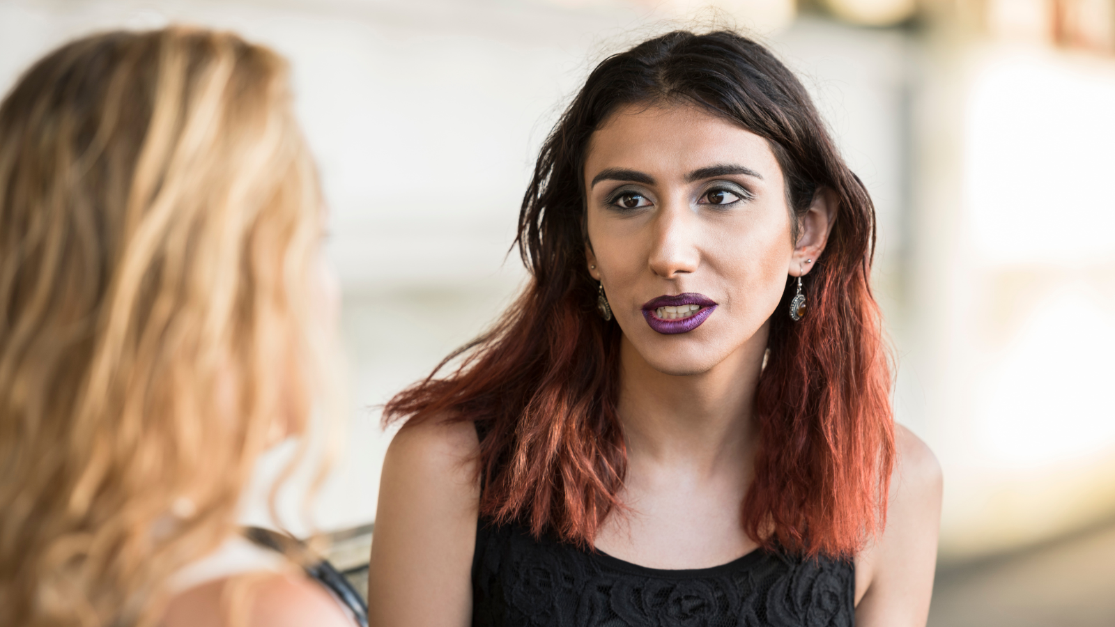 A woman talking to another person.