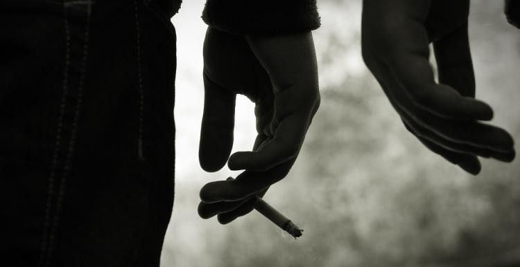 Hand holding cigarette.