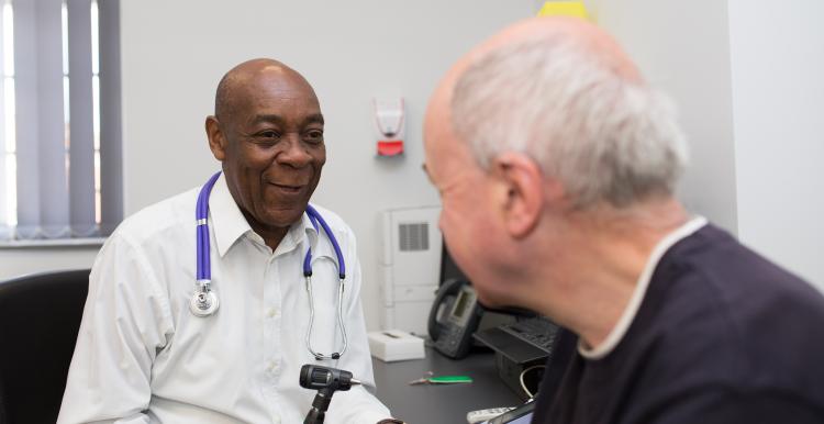 Physician and patient sitting.