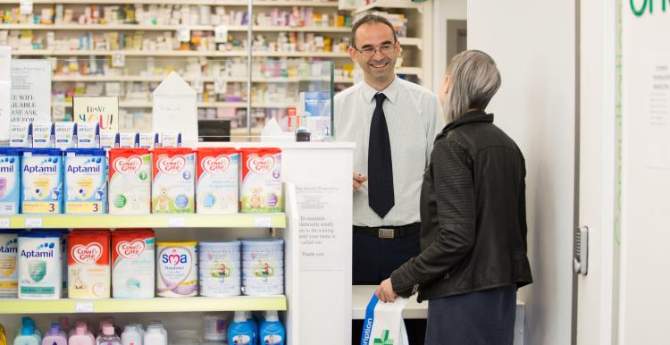 Pharmacist assisting customer.