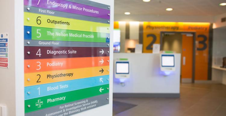 A hospital corridor with a sign