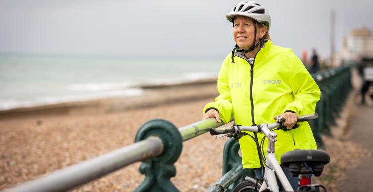 Woman and her bike by the Brighton shoreline.