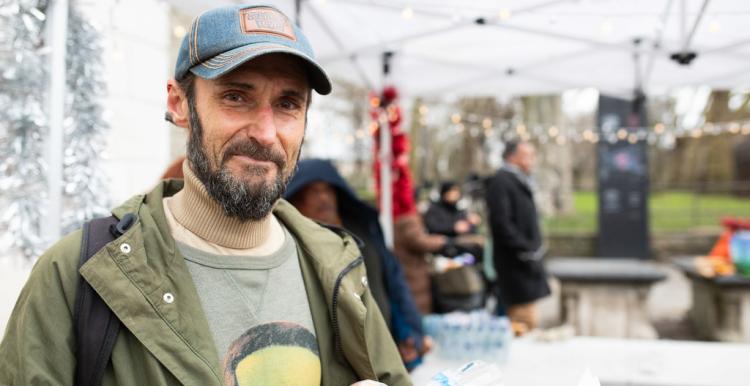 Man wearing cap in an outdoor setting.