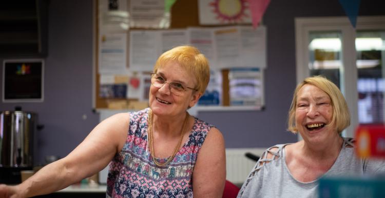 Two older women laughing.