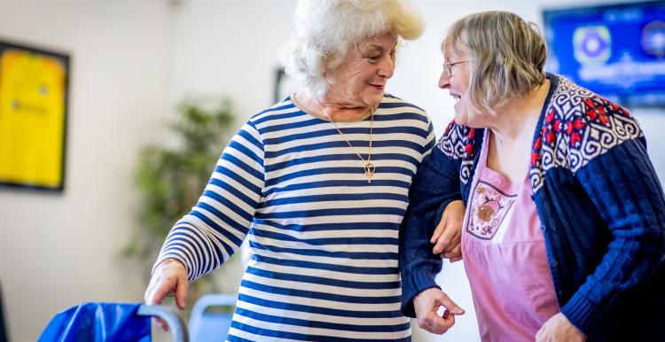Two older women laughing together.