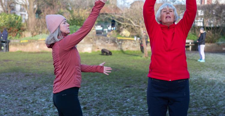 Two women exercising outside during winter. 