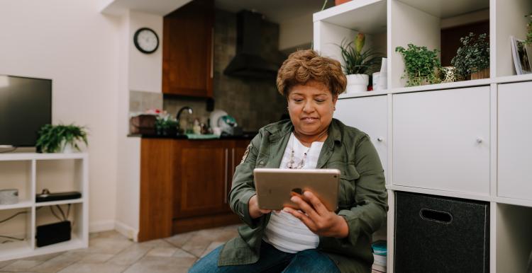 Woman looking at iPad indoors.