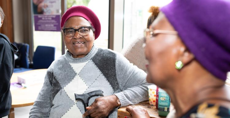 Two older women sat down and chatting