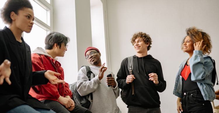 Young people talking in a corridor 