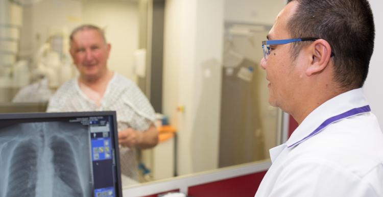 A radiographer working with a patient. 
