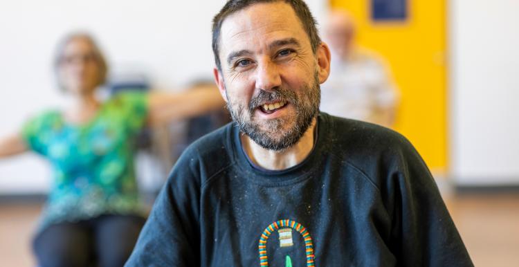 A man smiling indoors. 