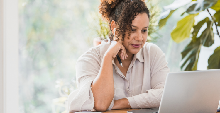 Woman reading a laptop screen indoors