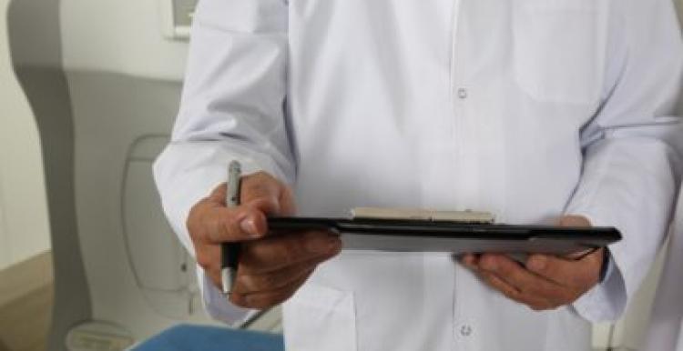 Photograph, Man in white coat holding clipboard, Front view, Shoulders and Below