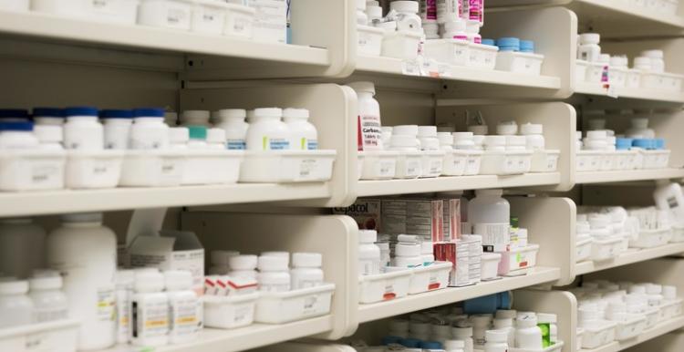 White Shelves, Full of different medications in various types of white bottles and containers