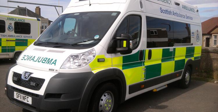 Ambulance, front side view, close to front of frame