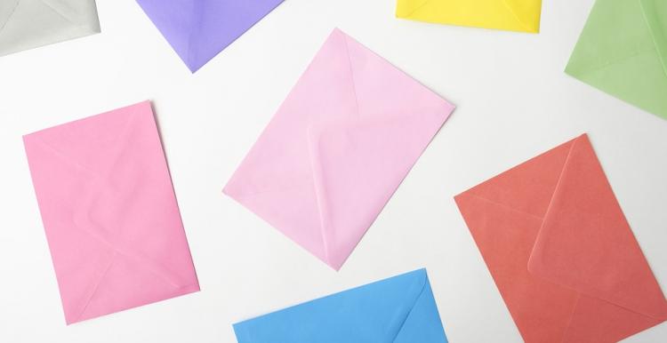 Photo, White backdrop, different coloured envelopes spread around