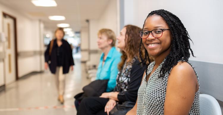 Woman smiling waiting in a hospital 