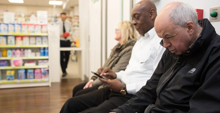 People waiting in pharmacy.