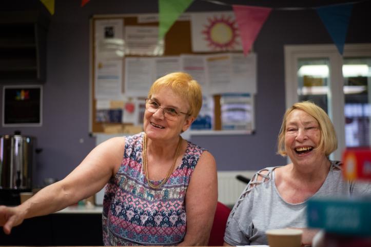 Two older women laughing.