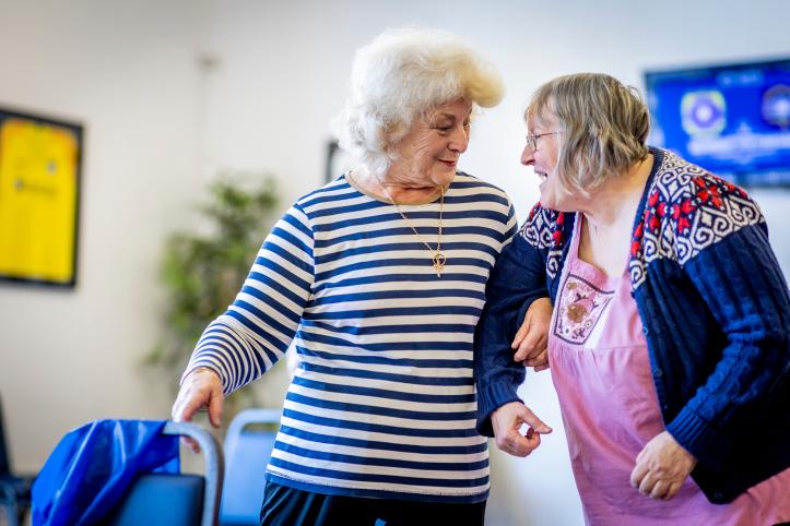 Two older women laughing together.