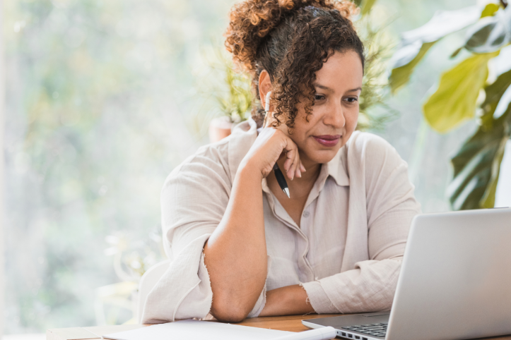 Woman reading a laptop screen indoors