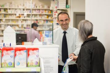 Pharmacist assisting customer.