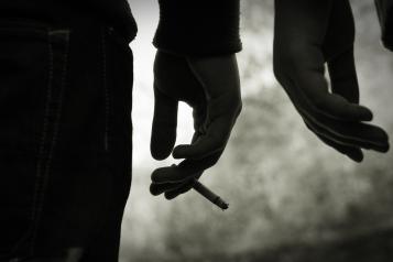 Hand holding cigarette.