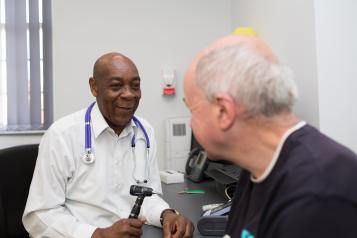 Physician and patient sitting.