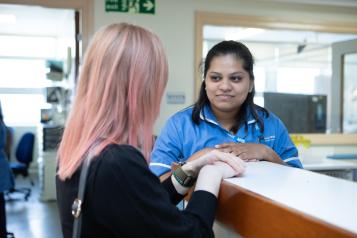 A woman speaking to a healthcare professional.