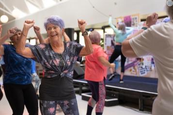 Older adults smiling while taking part in an exercise class