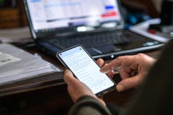 A close-up image of someone looking at their phone.