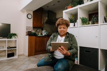 Woman looking at iPad indoors. 