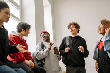 Young people talking in a corridor 