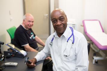Male doctor speaking to a patient