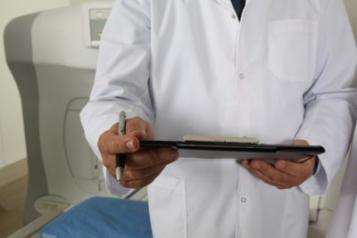 Photograph, Man in white coat holding clipboard, Front view, Shoulders and Below