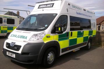 Ambulance, front side view, close to front of frame