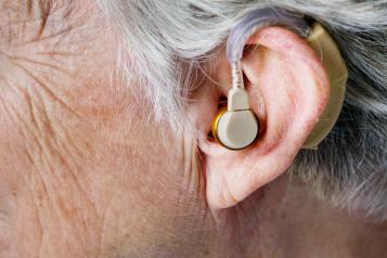 close up of hearing aid in an older person's ear