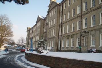 Front view of Brighton General, Snow Covers foreground and building