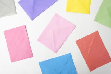 Photo, White backdrop, different coloured envelopes spread around