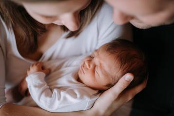 People holding newborn