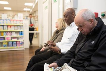 People waiting in pharmacy.