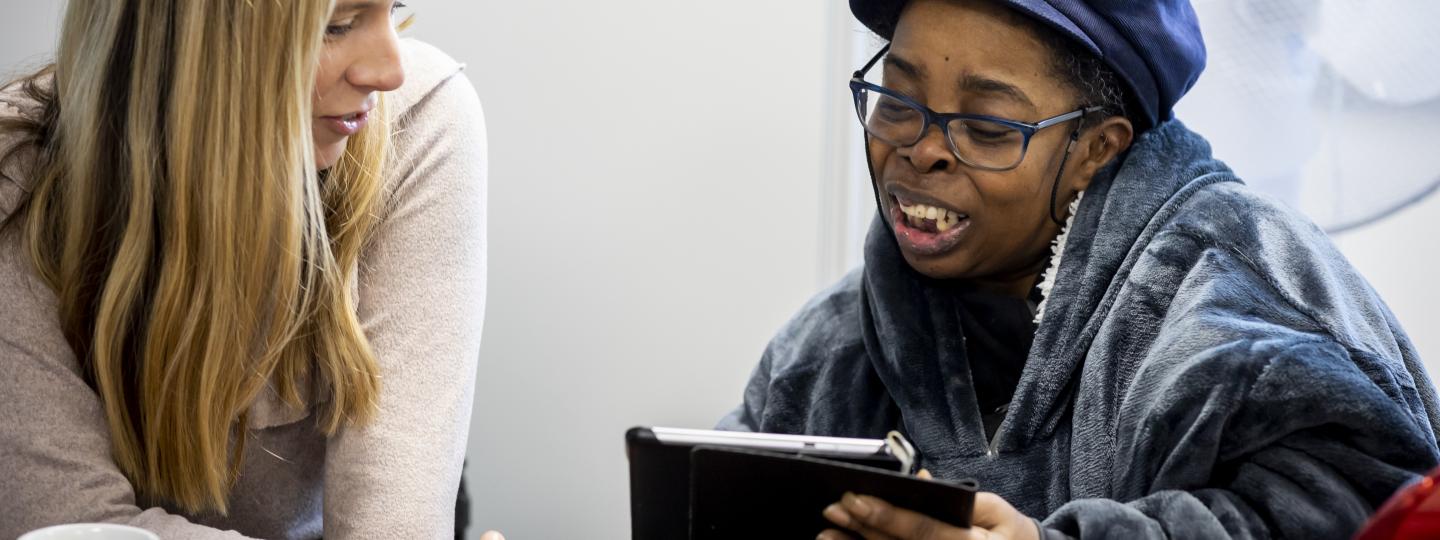 Two women looking at an iPad 