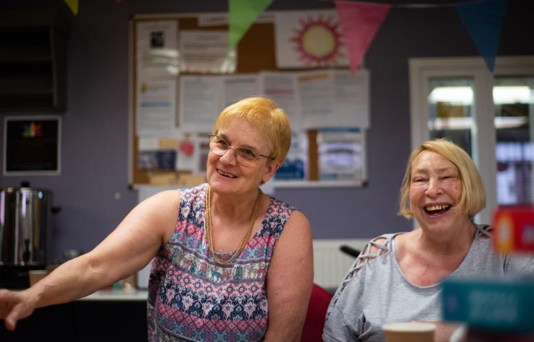 Two older women laughing.