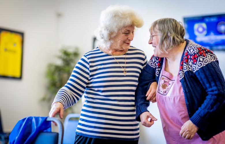 Two older women laughing together.