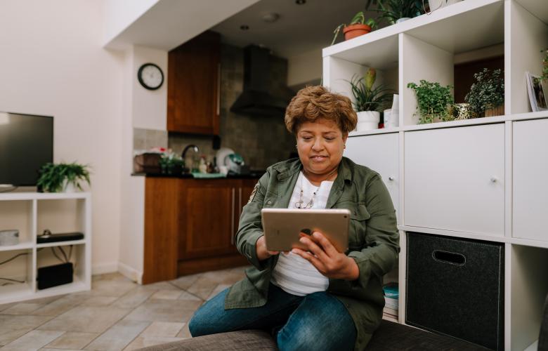 Woman looking at iPad indoors.