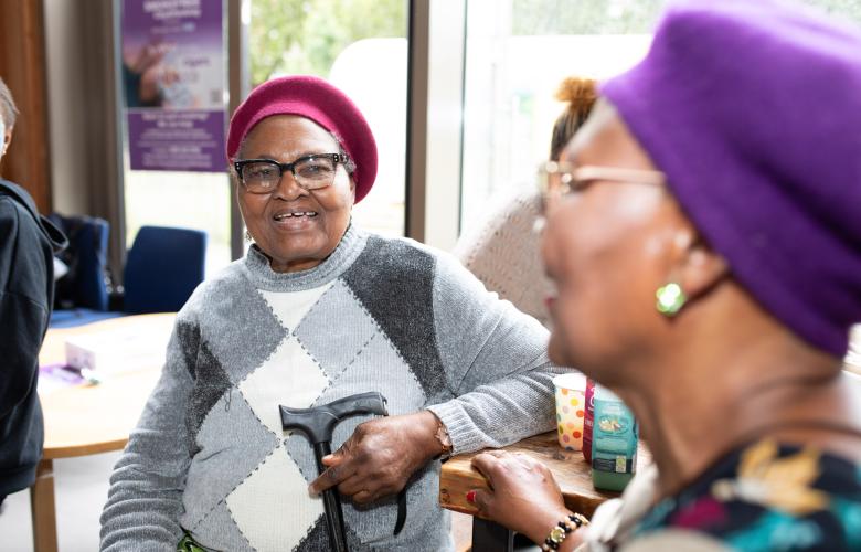 Two older women sat down and chatting