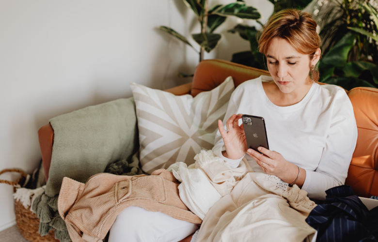 Woman using phone on sofa